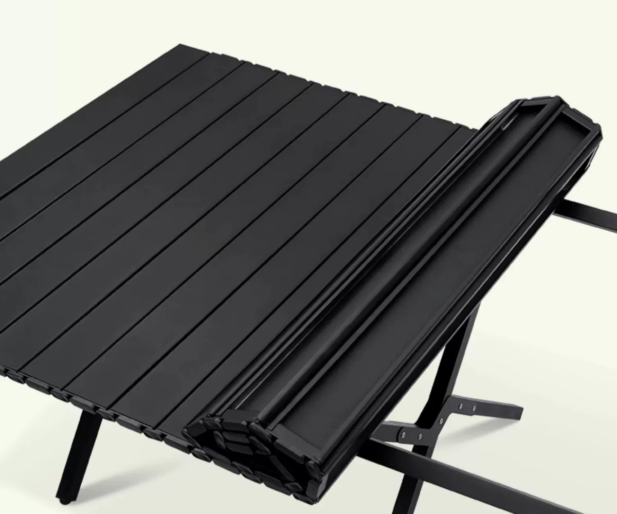 Black ECOTREK portable outdoor folding table in egg roll style, 120cm wide, suitable for camping and outdoor activities.