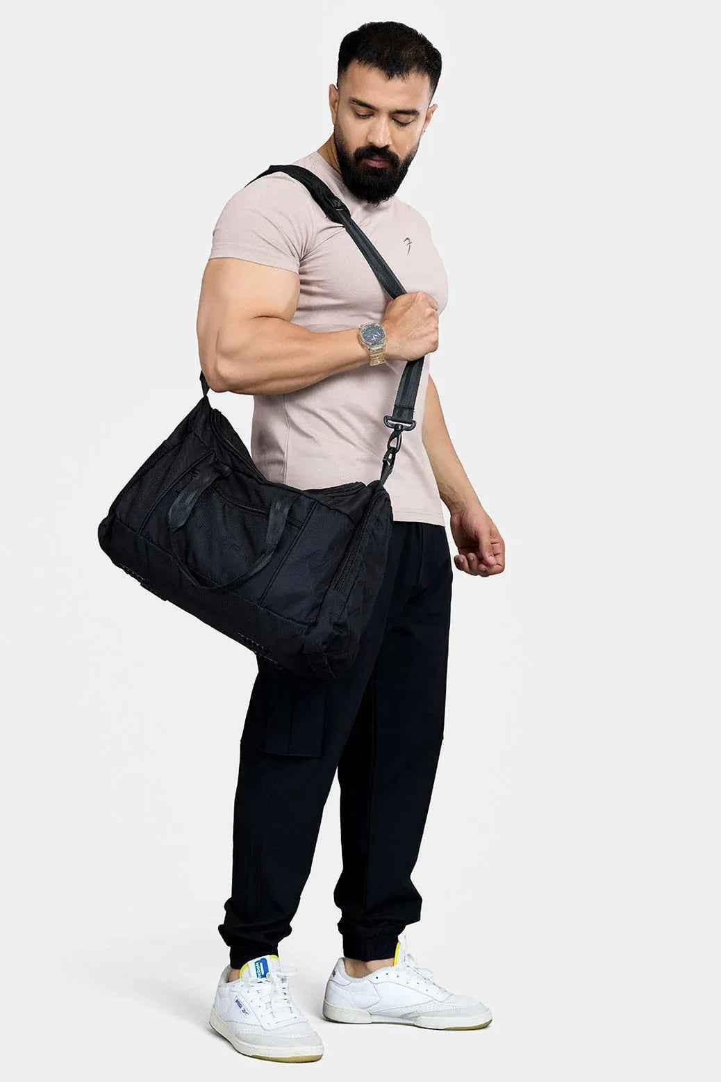Black Fuaark Nz duffle bag with sturdy handles and zipper, designed for stylish travel and easy carrying.