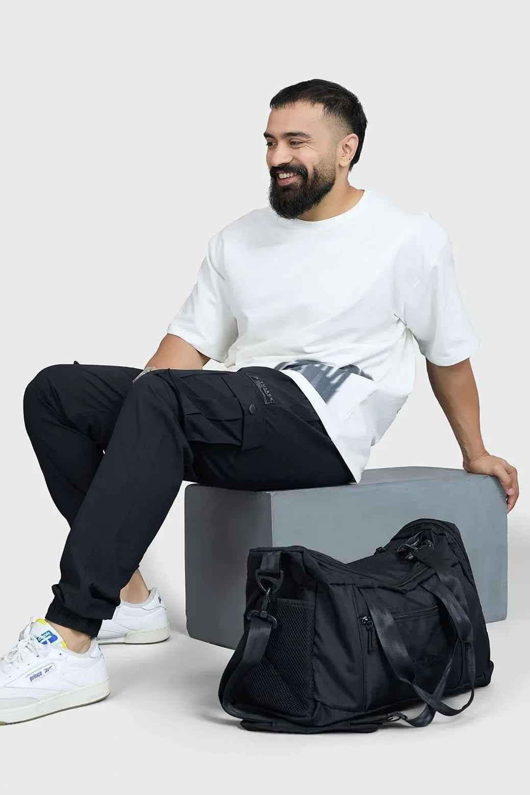 Black Fuaark Nz duffle bag with sturdy handles and zip closure, ideal for travel and outdoor adventures.
