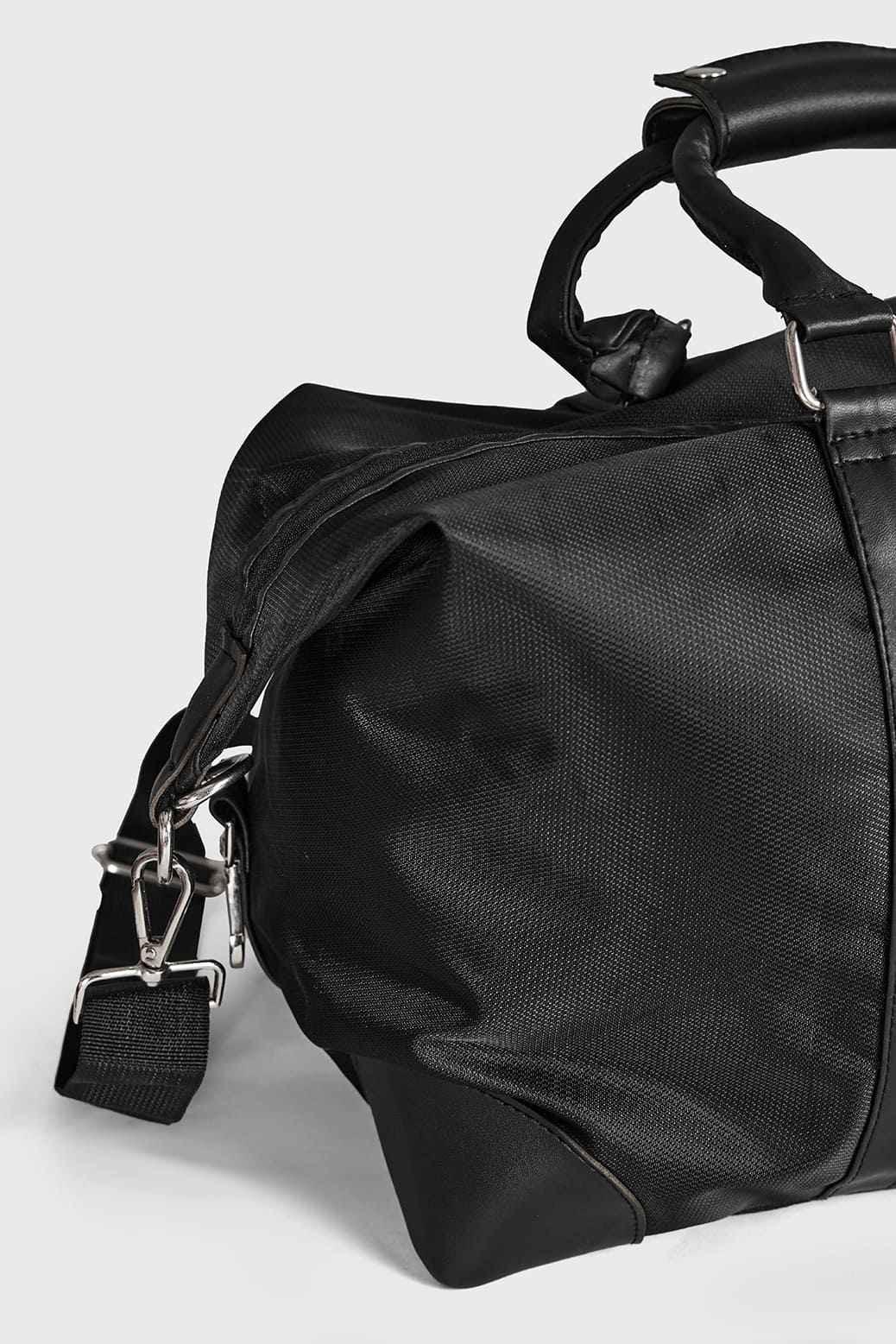 Black Vault Duffle Bag by Fuaark NZ featuring sturdy handles and spacious main compartment for travel or gym use.