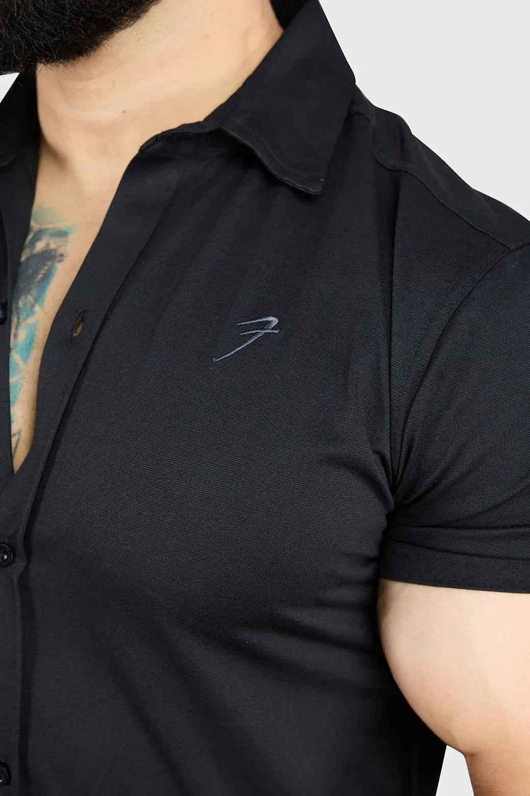 Black Aero casual shirt by Fuaark Nz, shown on a hanger with a close-up of the fabric and collar details.