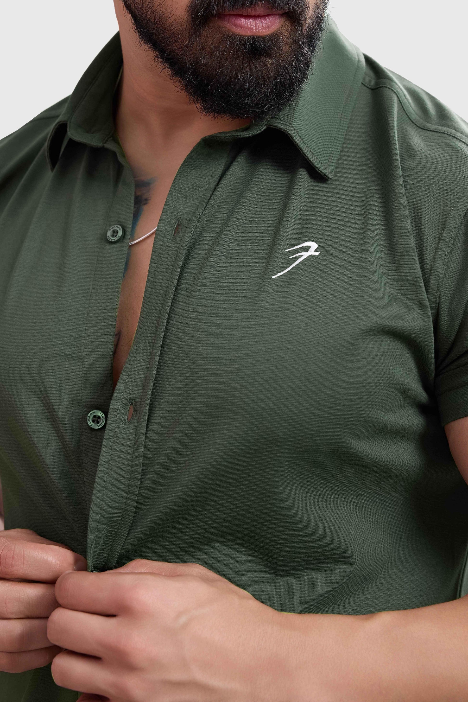 Olive Aero casual shirt by Fuaark NZ, featuring a relaxed fit and soft fabric, displayed on a hanger.