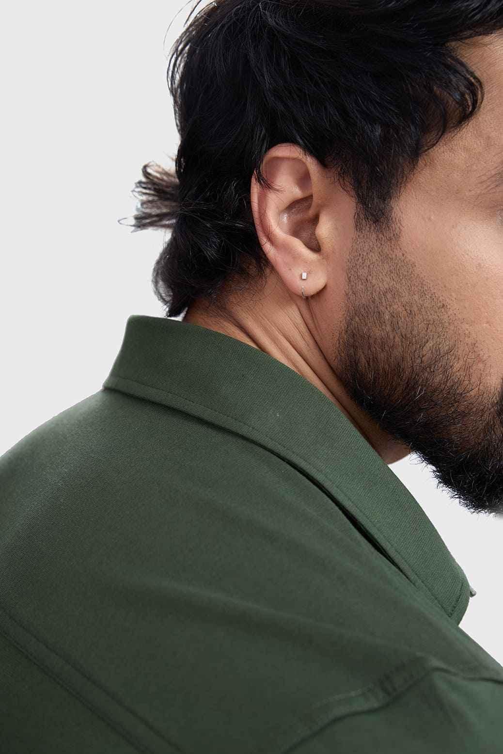 Olive green Fuaark Nz Aero casual shirt with a relaxed fit, displayed on a hanger against a neutral background.