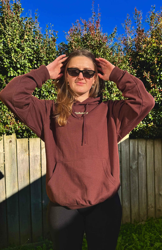 Unisex brown oversized hoodie by Fuaark Nz, displayed on a model with a casual fit and relaxed style.