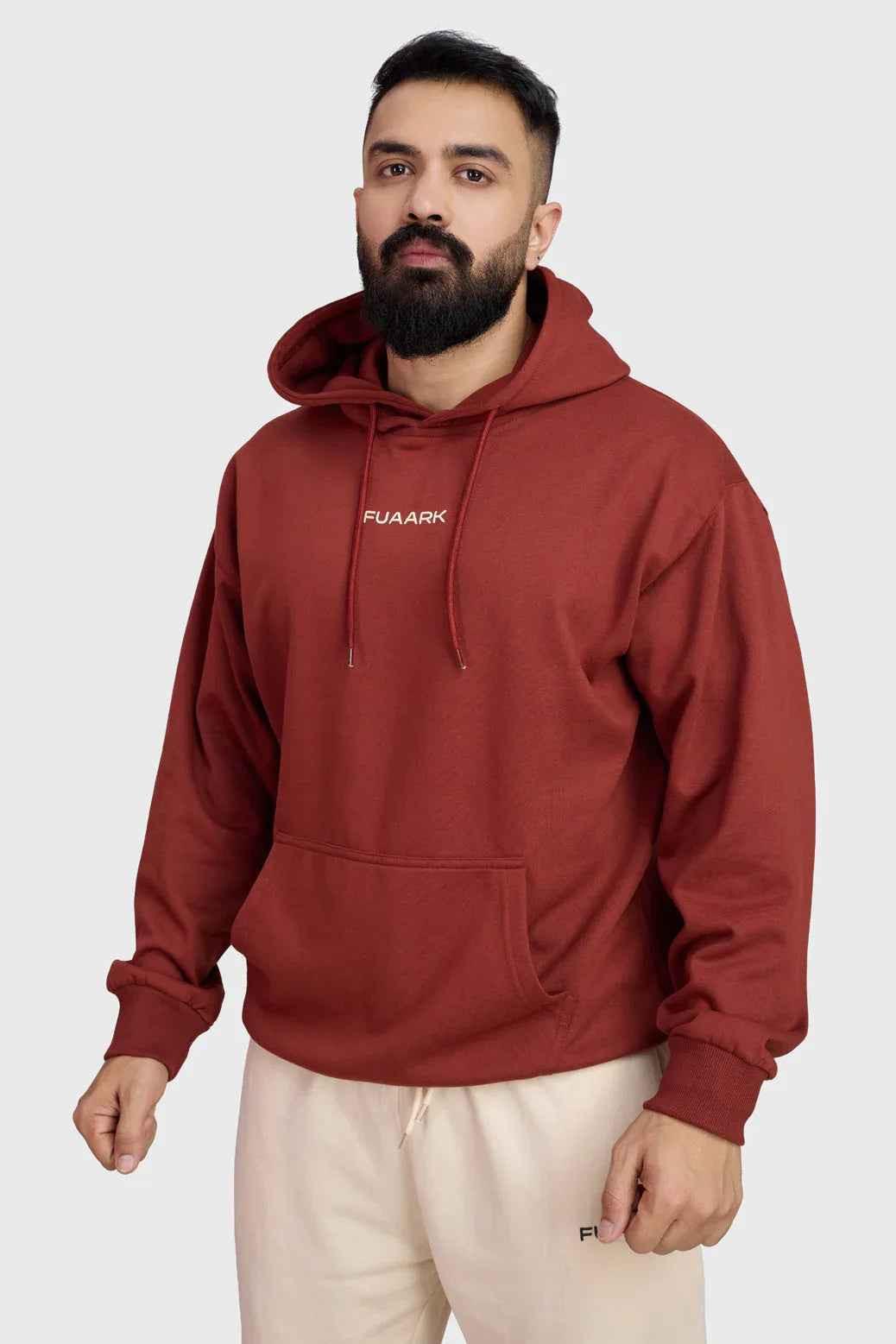 Fuaark Nz Signature Oversized Rust Hoodie for comfort and style, showcasing the relaxed fit and soft fabric in a natural setting.