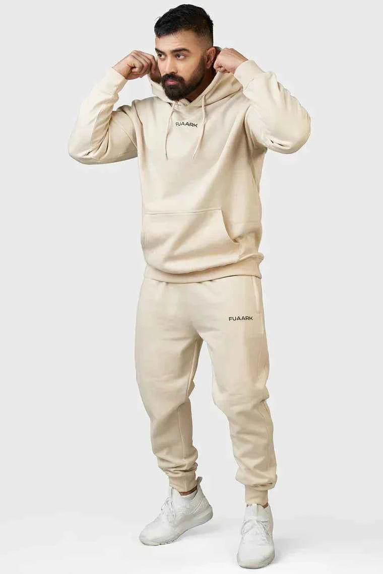 Beige unisex oversized hoodie by Fuaark NZ, stylish and comfortable, shown on a model with a relaxed fit and casual design.