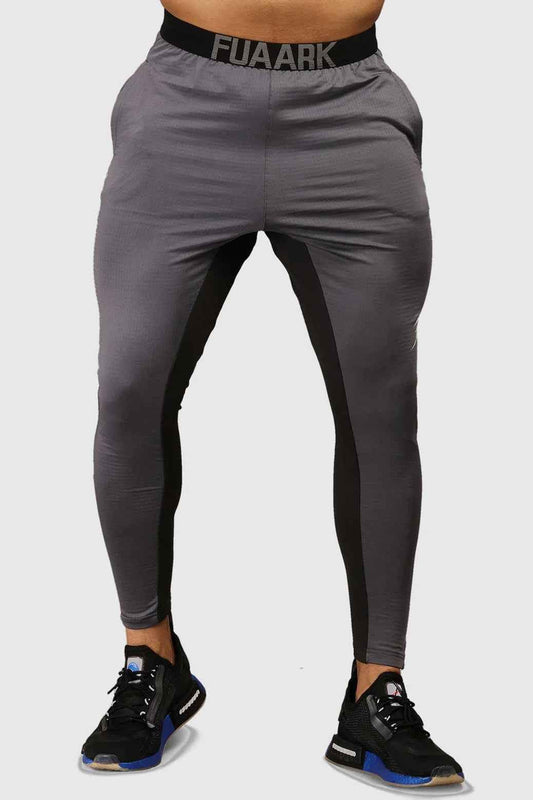 Fuaark Nz grey joggers with box tracks, offering stylish comfort and versatility, shown on a model.