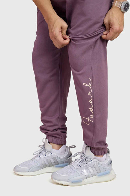 Fuaark Nz mauve oversized joggers made of soft, comfortable fabric, displayed laid flat showing relaxed fit and stylish design.