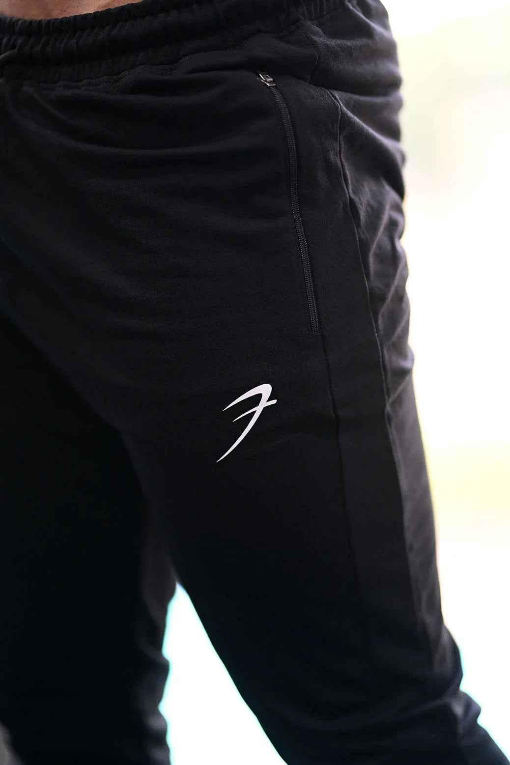 Black fall joggers by Fuaark NZ, comfortable activewear pants with a relaxed fit for casual and athletic wear.