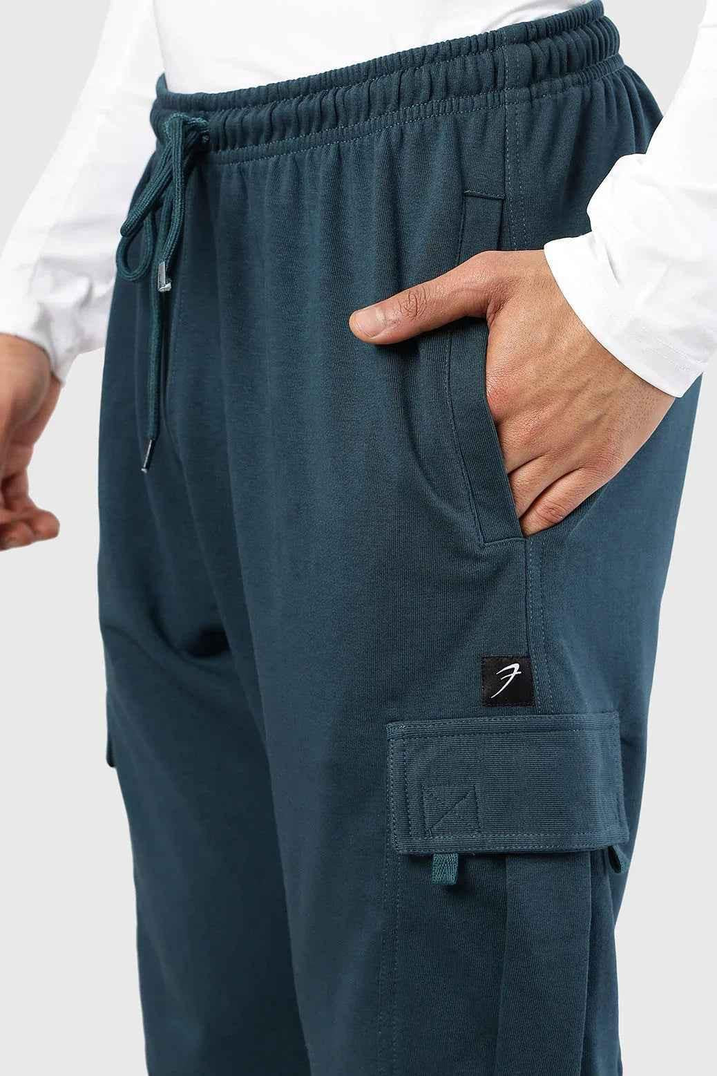 Teal Flex Joggers by Fuaark Nz, featuring a comfortable fit and casual style, shown on a model with pockets and elastic waistband.