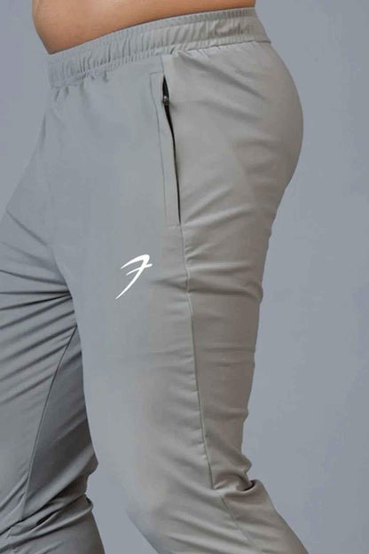 Fuaark Nz Identity Nylon Joggers in light grey, slim-fit athletic pants with elastic waistband and side pockets.