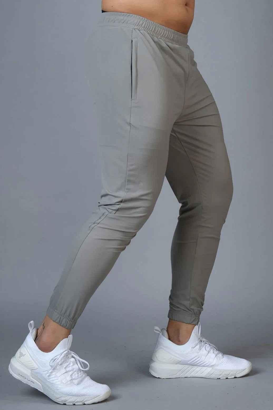Light grey nylon joggers from Fuaark Nz featuring a relaxed fit and adjustable waistband, ideal for casual wear.