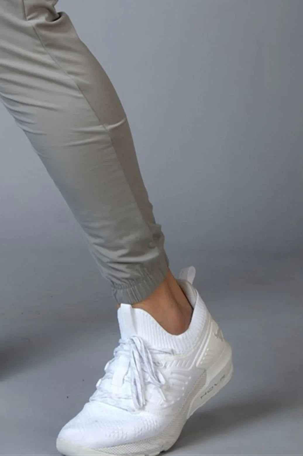 Light grey Fuaark Nz Identity Nylon Joggers, slim-fit athletic pants with drawstring waist and modern design.