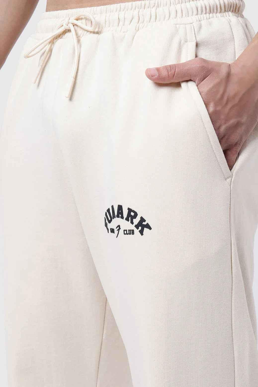 Beige Fuaark Nz laidback relaxed joggers pants with comfortable fit and casual style, shown on a model.