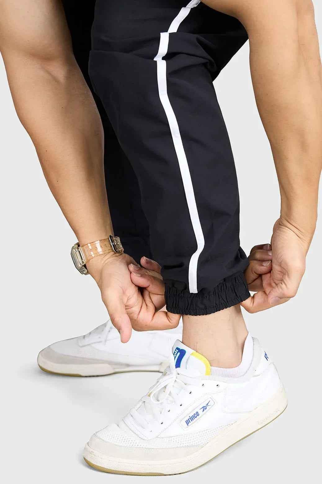 Black lifting joggers by Fuaark Nz, designed for comfortable community workouts, shown in a relaxed fit with athletic features.