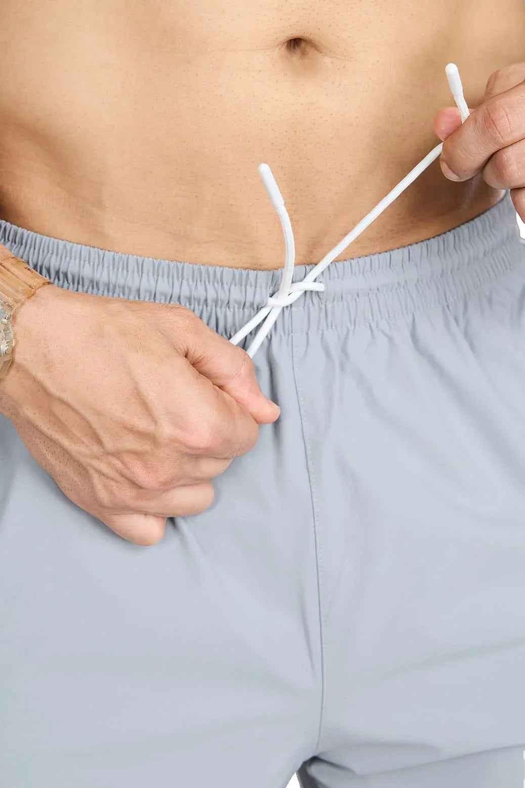 Light grey Fuaark Nz lifting community joggers, slim fit athletic pants with drawstring waist and sporty design.