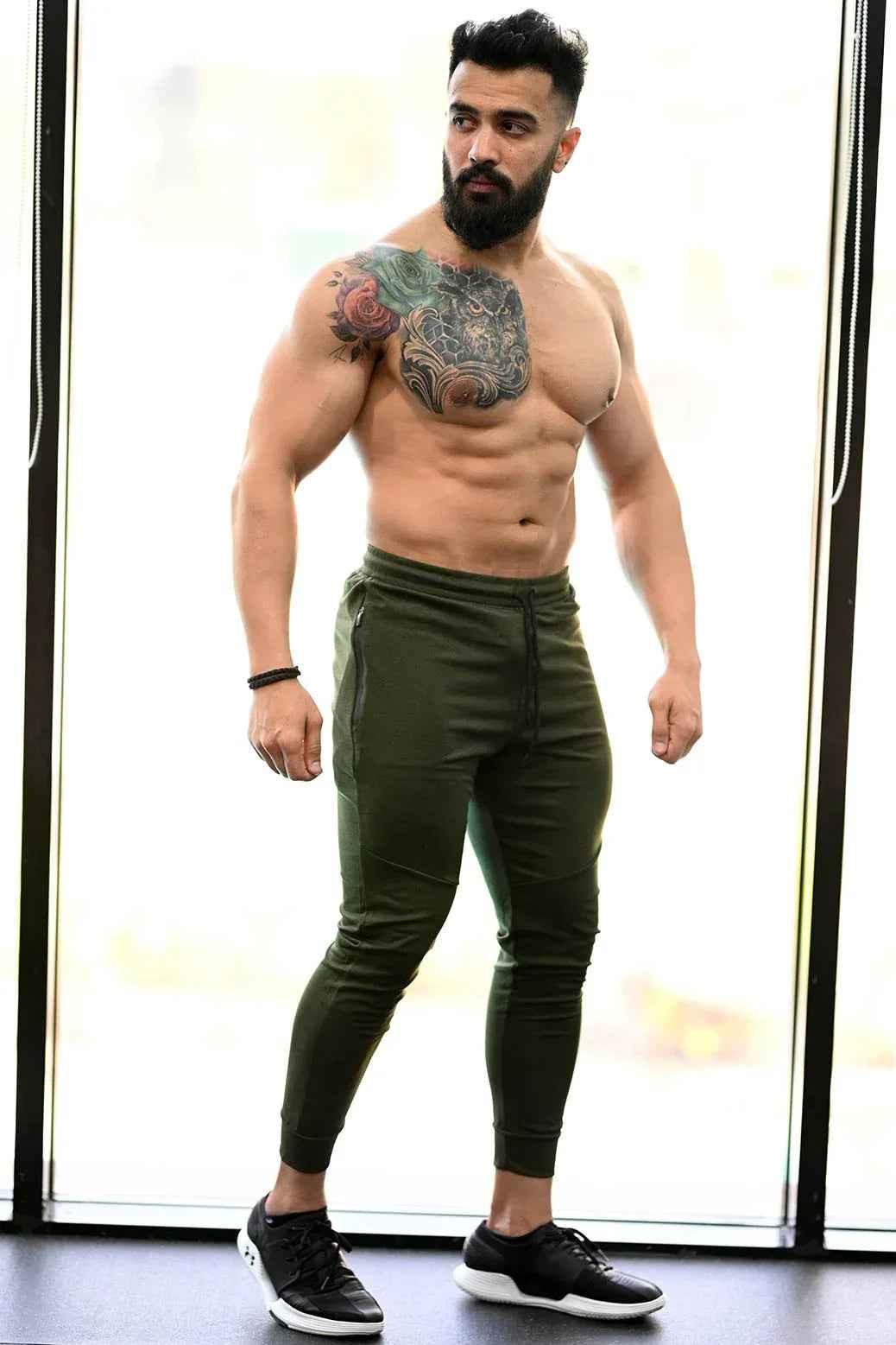 Fuaark Nz melange green joggers for comfortable style, shown on a model, featuring relaxed fit and soft fabric.