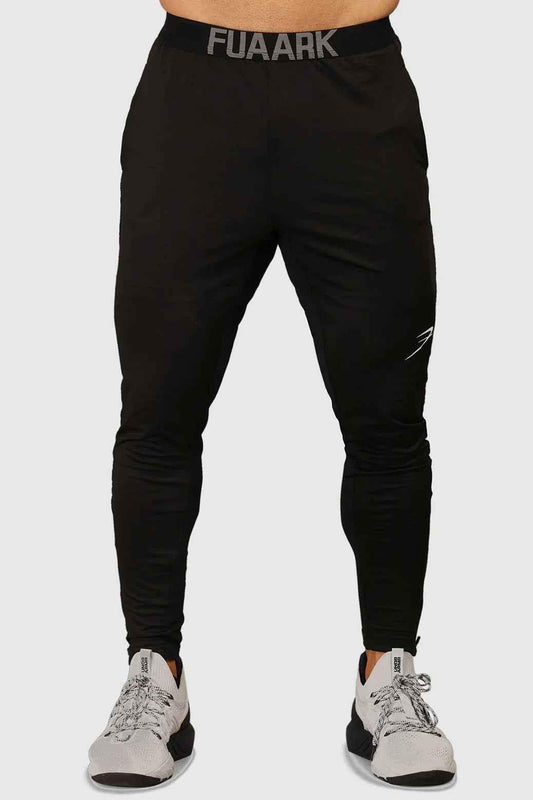Black men's joggers by Fuaark Nz featuring a comfortable fit and stylish design, shown on a model.