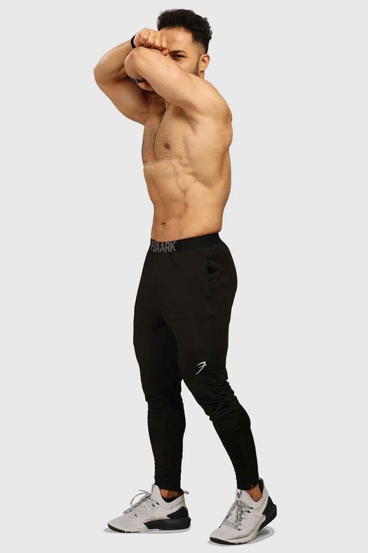 Black men's joggers from Fuaark Nz with a comfortable fit and stylish design, shown on a model in a casual setting.