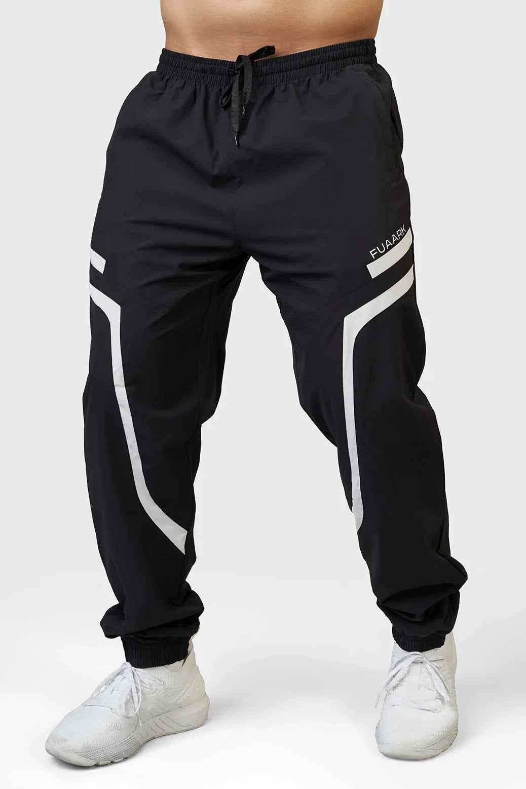 Black Fuaark Nz Momentum Joggers, comfortable athletic pants with a relaxed fit and elastic waistband, shown on a model.