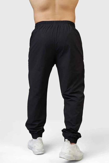 Black Fuaark Nz Momentum Joggers laid flat, showing the comfortable fit, elastic waistband, and sleek jogger style.