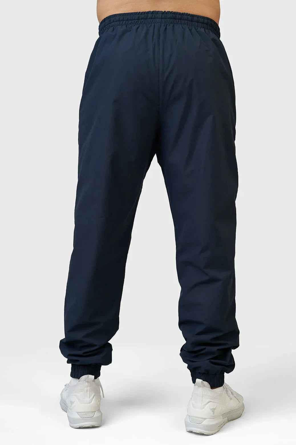 Navy Fuaark Nz Momentum Joggers laid flat showing elastic waistband and tapered fit, ideal for casual wear and workouts.