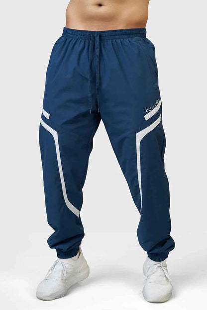 Fuaark Nz Momentum Joggers in Teal, shown on a model, featuring a comfortable fit and stylish design for casual wear.