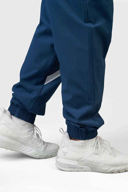 Fuaark Nz Momentum Joggers in teal color, casual athletic pants with an elastic waistband and tapered fit.