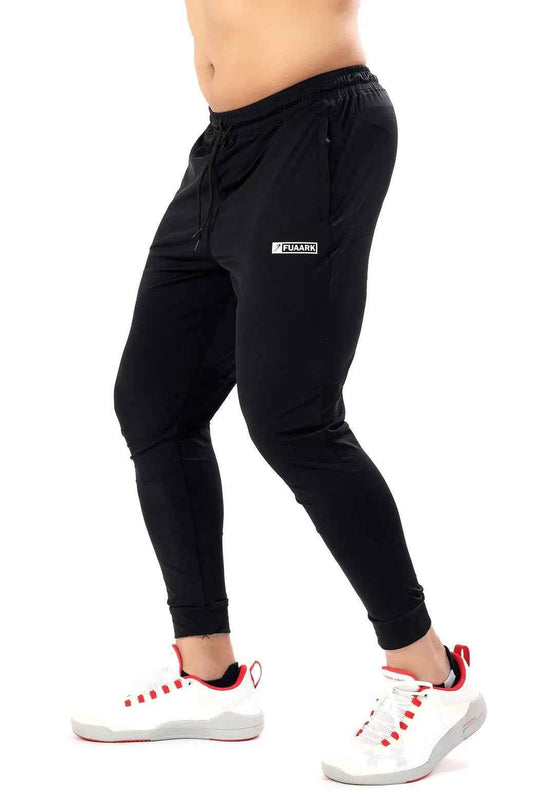 Black nylon joggers by Fuaark Nz featuring a comfortable fit and stylish design for everyday wear.