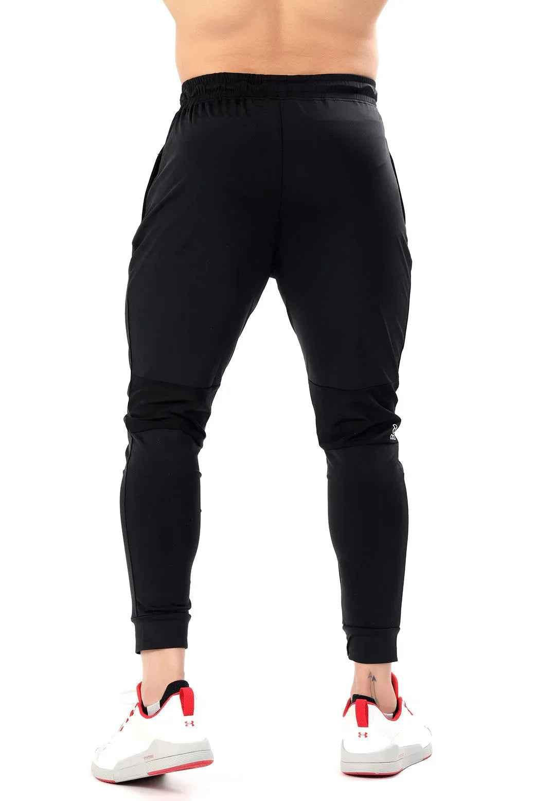 Black nylon joggers by Fuaark Nz featuring a sleek design and comfortable fit, perfect for casual and athletic wear.