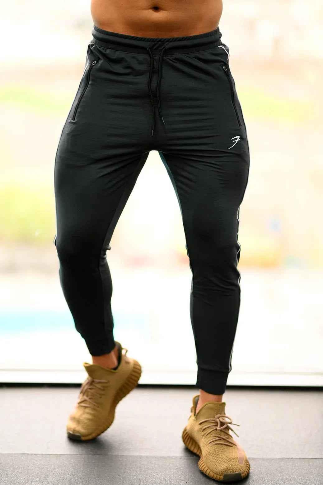 Steel grey Fuaark Nz Revival Joggers, casual jogger pants with a relaxed fit and elastic waistband, shown in a close-up view.