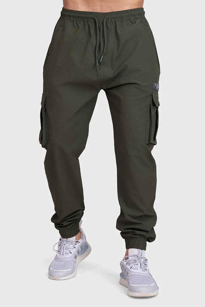 Fuaark Nz army script cargo joggers in olive green with multiple pockets and drawstring waistband, casual athletic style.