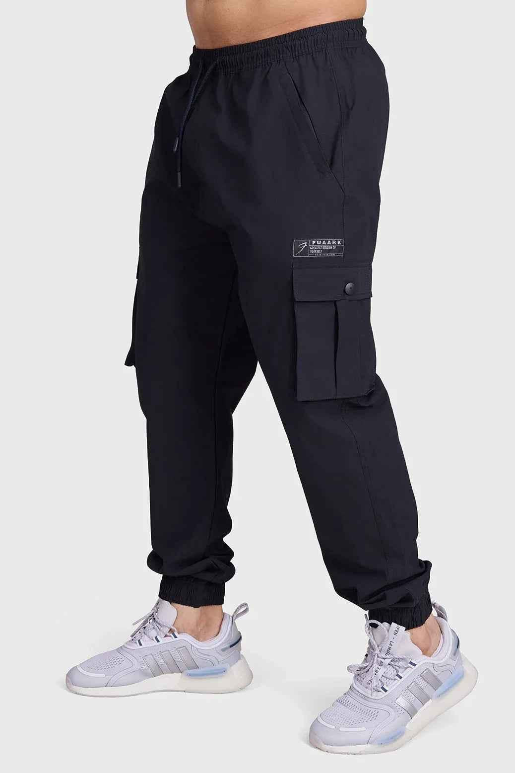 Black Script Cargo Joggers from Fuaark Nz featuring multiple pockets and a relaxed fit, suitable for casual and athletic wear.