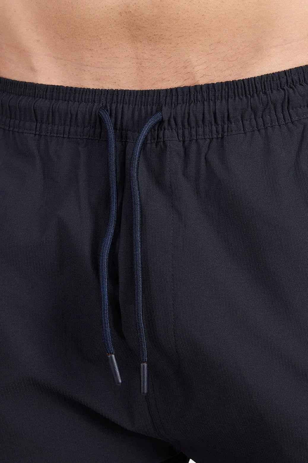 Black Fuaark Nz Script Cargo Joggers with multiple pockets and relaxed fit, shown on a model.