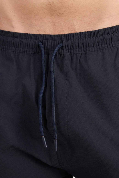 Black Fuaark Nz Script Cargo Joggers with multiple pockets and relaxed fit, shown on a model.