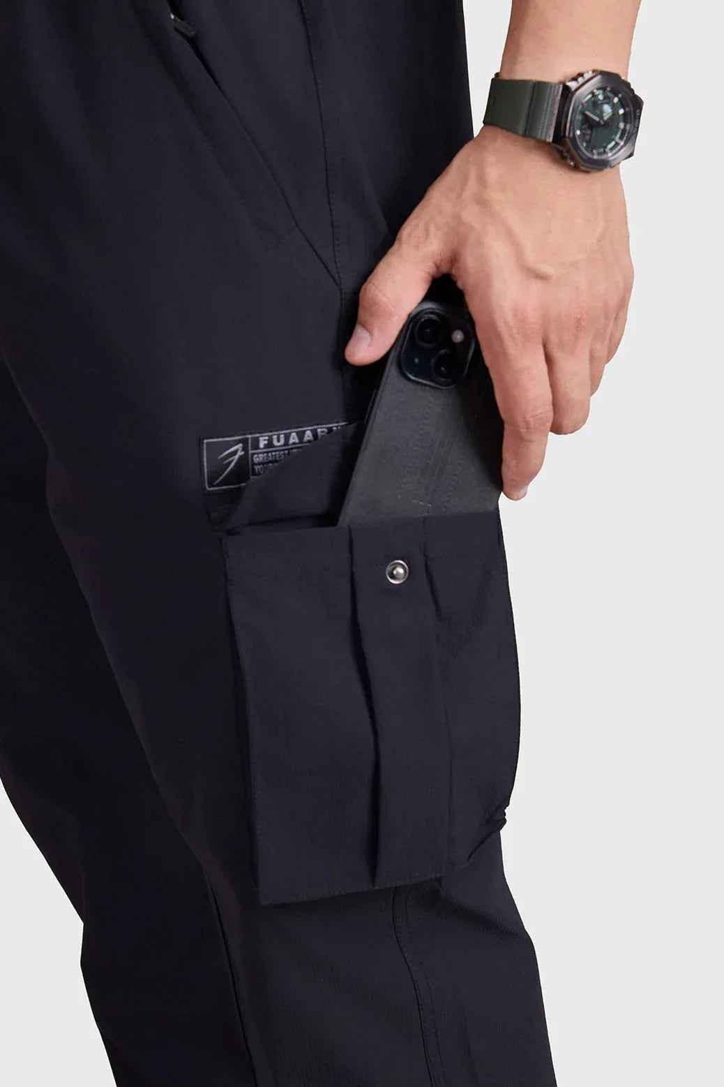 Black Fuaark Nz Script Cargo Joggers, featuring a relaxed fit and multiple cargo pockets, shown on a model.