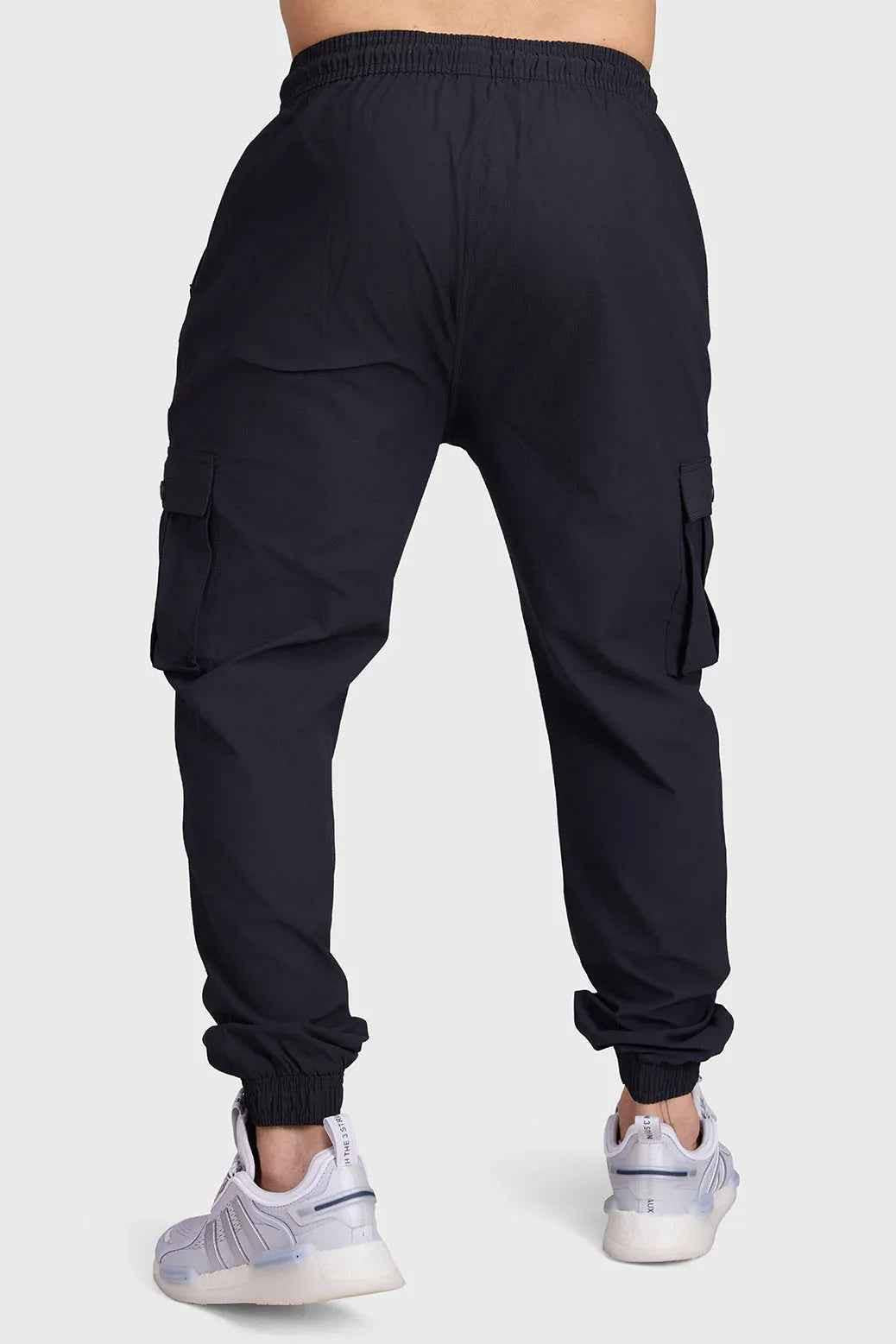 Black Script Cargo Joggers by Fuaark Nz featuring multiple pockets and relaxed fit, made from comfortable fabric.