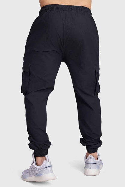 Black Script Cargo Joggers by Fuaark Nz featuring multiple pockets and relaxed fit, made from comfortable fabric.