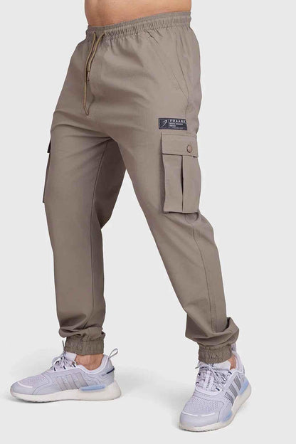 Brown Script Cargo Joggers by Fuaark Nz, featuring a relaxed fit with multiple cargo pockets and comfortable fabric.