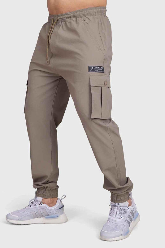 Brown Script Cargo Joggers by Fuaark Nz, featuring a relaxed fit with multiple cargo pockets and comfortable fabric.