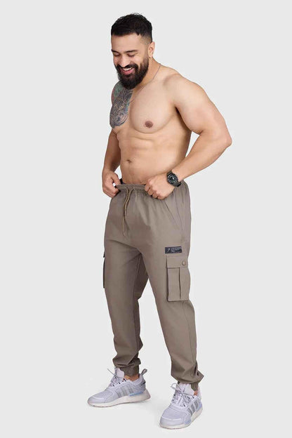 Brown Script Cargo Joggers by Fuaark Nz, featuring a relaxed fit and multiple cargo pockets, made from comfortable fabric.