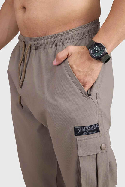 Brown Script Cargo Joggers by Fuaark Nz, featuring a relaxed fit with multiple cargo pockets and comfortable fabric.