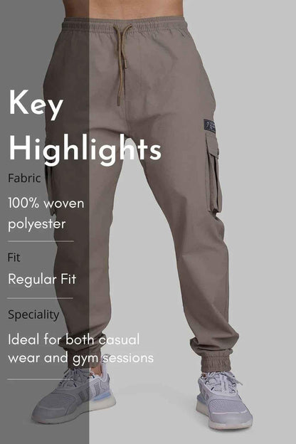 Brown Script Cargo Joggers by Fuaark Nz with multiple pockets and relaxed fit, shown on a model against a neutral background.