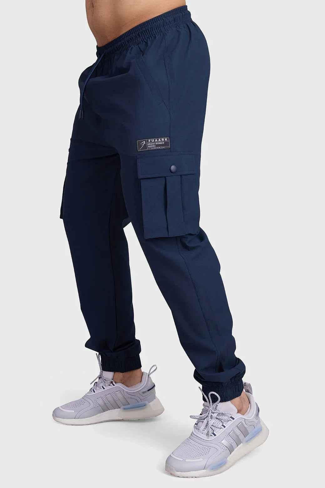 Dark navy Fuaark NZ Script Cargo Joggers displayed on a model, featuring relaxed fit and cargo pockets for casual style.