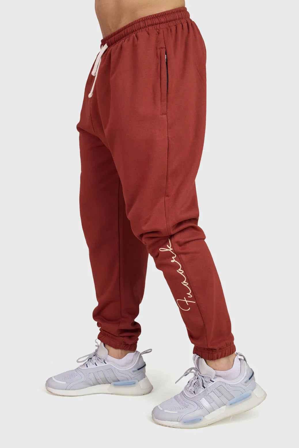 Rust-colored Signature Oversized Band Joggers by Fuaark Nz, showing relaxed fit and stylish design details.