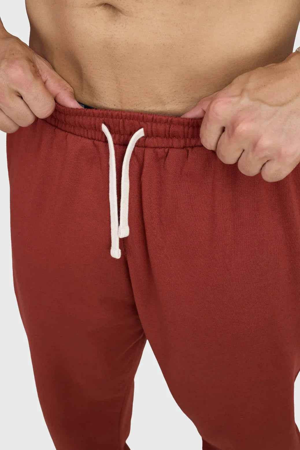 Fuaark Nz Signature Oversized Band Joggers in rust color, showing relaxed fit and bold band detail on the legs.