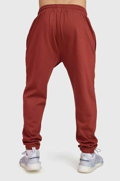 Rust-colored Fuaark Nz Signature Oversized Band Joggers, casual fit with bold band detail, made from comfortable jogger fabric.