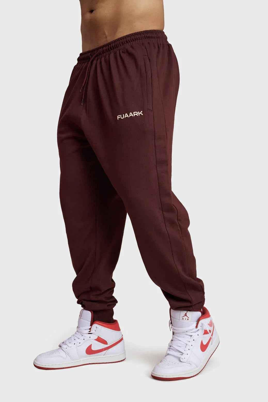 Fuaark Nz Signature Oversized Brown Joggers displayed on a hanger, showcasing their relaxed fit and soft fabric for casual comfort.