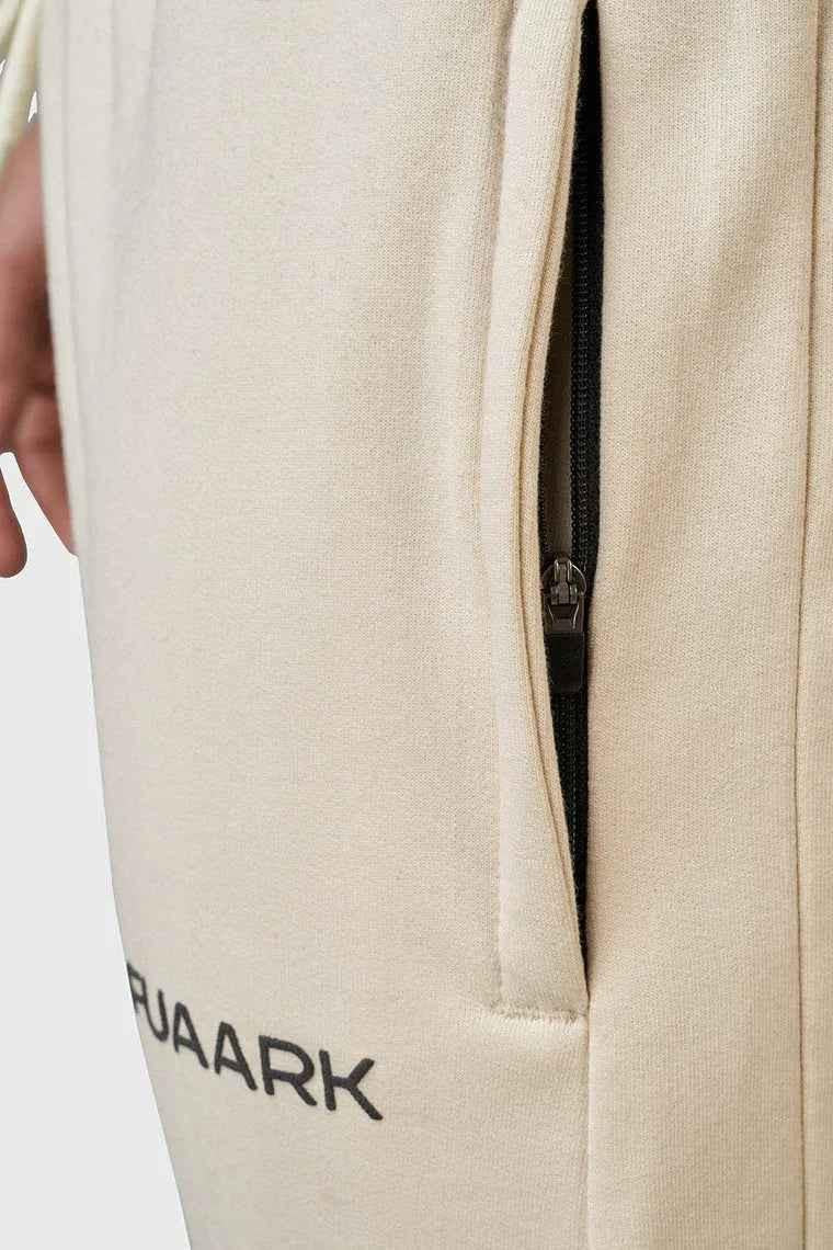 Beige oversized signature joggers from Fuaark Nz with relaxed fit and elastic waistband, casual and comfortable for everyday wear.