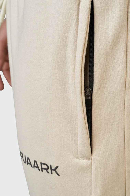 Beige oversized signature joggers from Fuaark Nz with relaxed fit and elastic waistband, casual and comfortable for everyday wear.